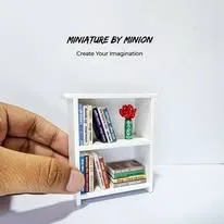 A bookshelf held in two fingers